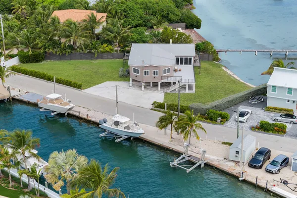 an aerial view of a house with a garden and lake view