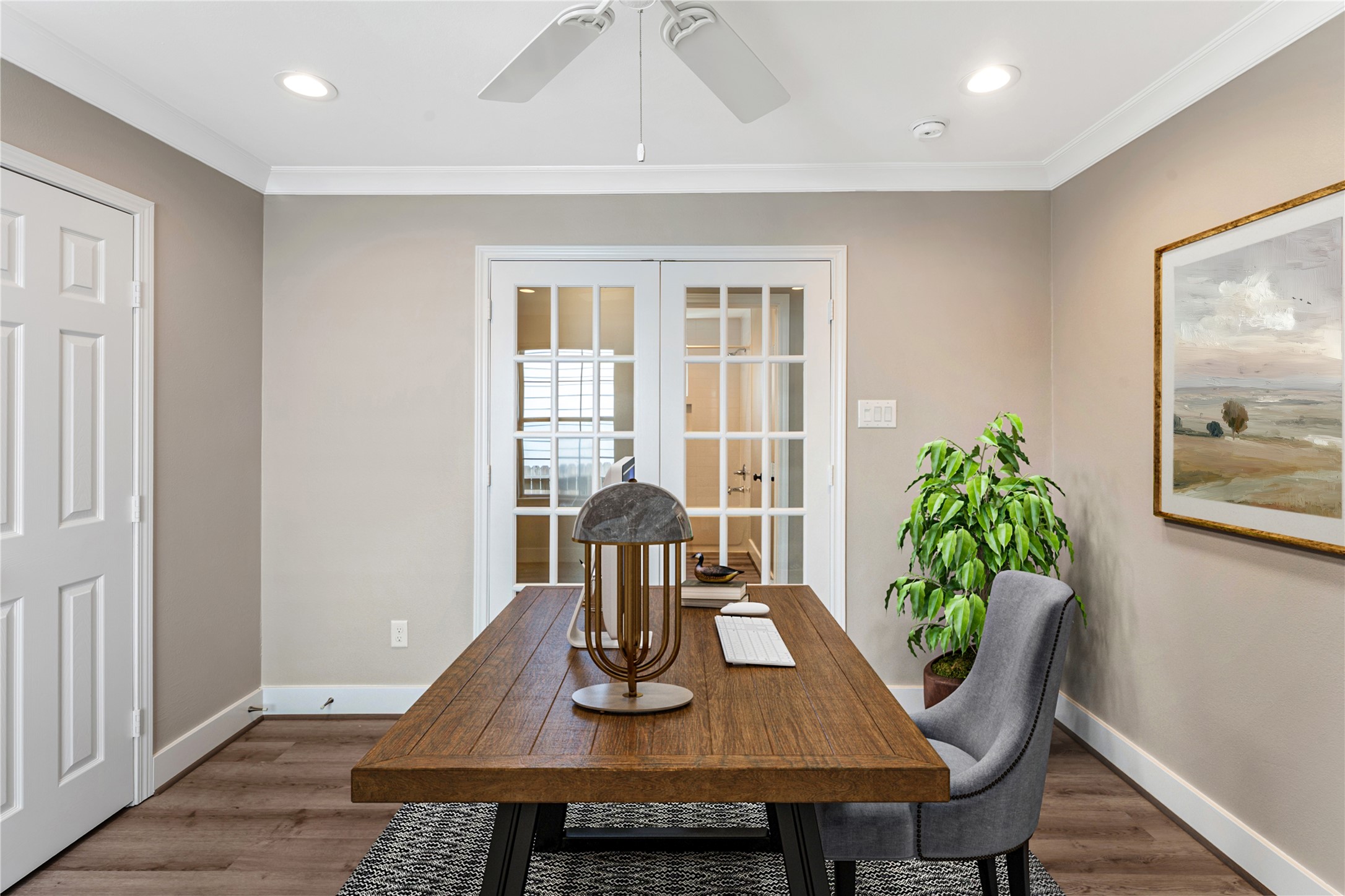 809 East 40th Street Houston, TX 77022 - Photo 19 of 27 Secondary bedroom with closet that has built-in shelving. This versatile flex space with beautiful flooring and French doors, perfect for a home office, study, or additional living area. virtually staged