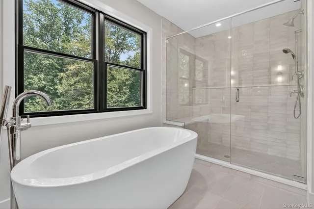 a white bath tub sitting next to a window