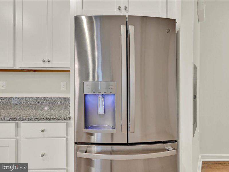 4003 Seaside Alder Road, Unit 307 HOLLY Bowie, MD 20720 - Photo 12 of 28 a kitchen with a refrigerator and cabinets