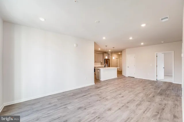 a view of a kitchen with a sink and a refrigerator