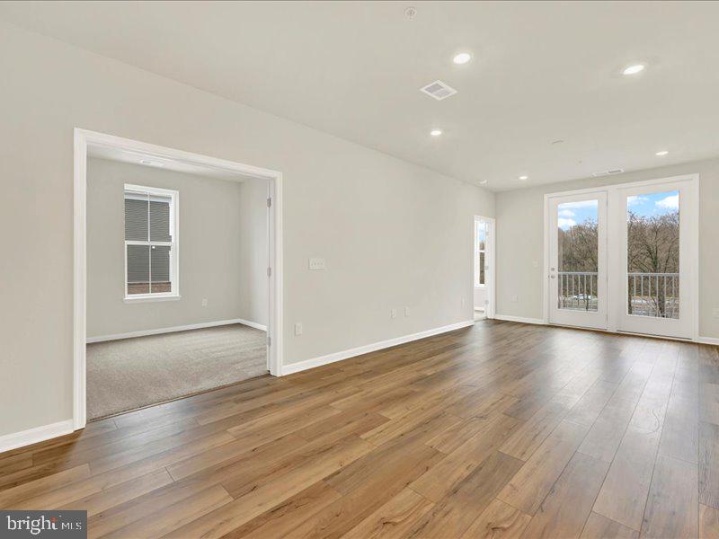 4003 Seaside Alder Road, Unit 307 HOLLY Bowie, MD 20720 - Photo 16 of 28 a view of empty room with wooden floor and fan
