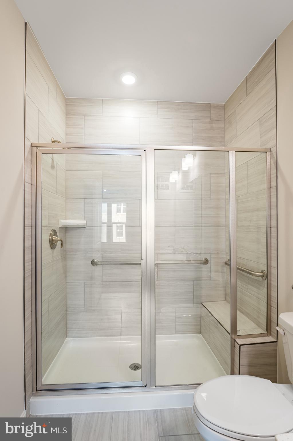 4003 Seaside Alder Road, Unit 307 HOLLY Bowie, MD 20720 - Photo 23 of 23 a bathroom with a shower and toilet