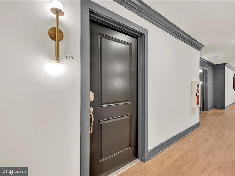 4003 Seaside Alder Road, Unit 307 HOLLY Bowie, MD 20720 - Photo 27 of 28 a view of a hallway with wooden cabinets