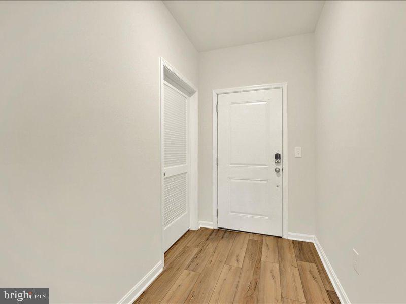 4003 Seaside Alder Road, Unit 307 HOLLY Bowie, MD 20720 - Photo 4 of 28 a view of a small space with wooden floor and a bathroom
