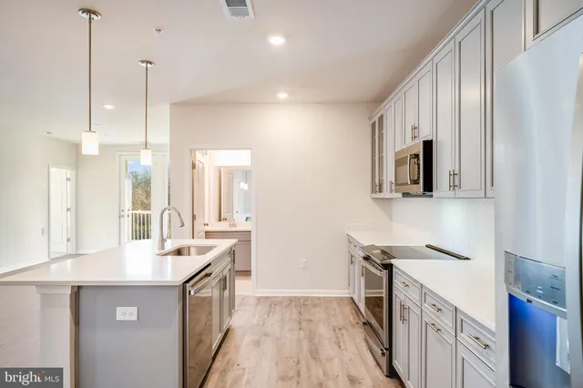 a kitchen with a sink and a refrigerator