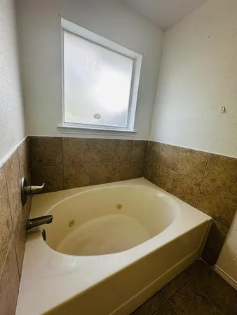 a kitchen with granite countertop a sink cabinets and stainless steel appliances