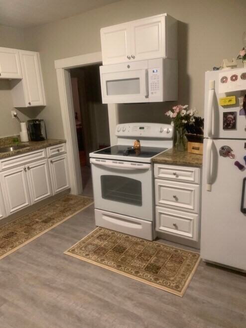 31 Snowling Road, Unit 2 Uxbridge, MA 01569 - Photo 2 of 6 a kitchen with granite countertop a sink cabinets and stainless steel appliances