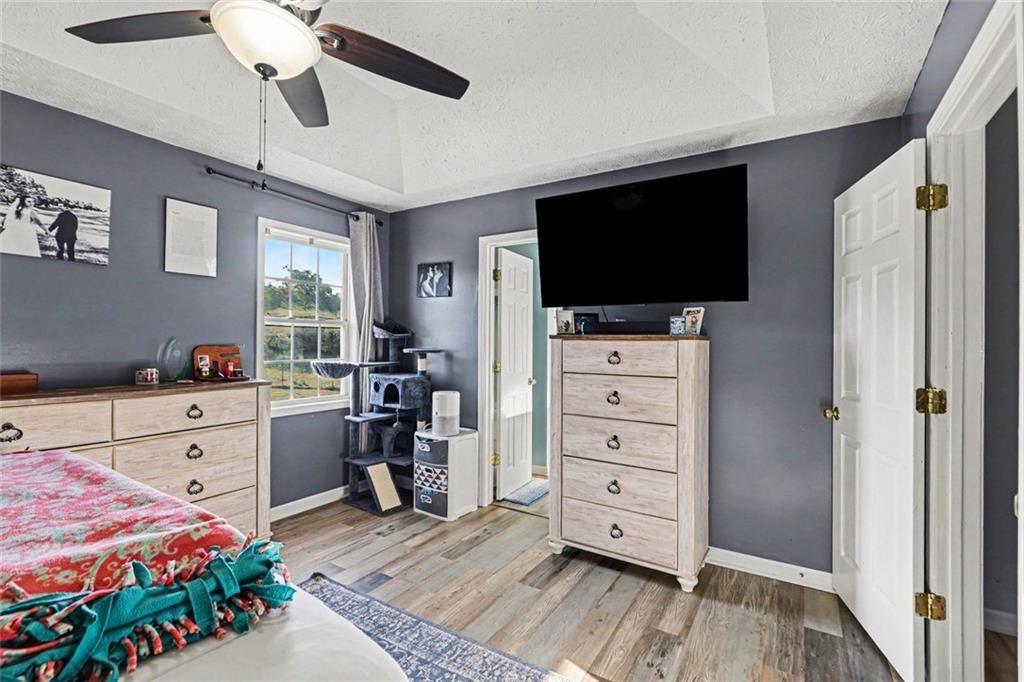 302 Fairview Lane Dallas, GA 30157 - Photo 13 of 26 a bedroom with a bed and a flat tv screen on dresser