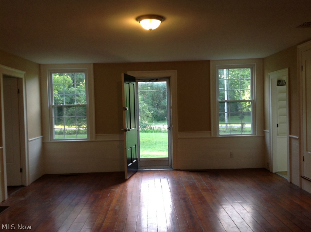 1764 Ridgewood Road Wadsworth, OH 44281 - Photo 2 of 24 Living room with original hardwood flooring and wood planking on bottom half of walls. Freshly painted with colors to the era of when the home was built.