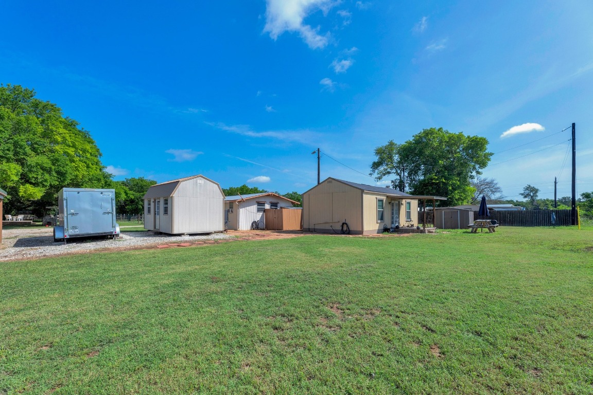 148 Meadows Drive Elgin, TX 78621 - Photo 1 of 38 a view of a tiny house with a yard