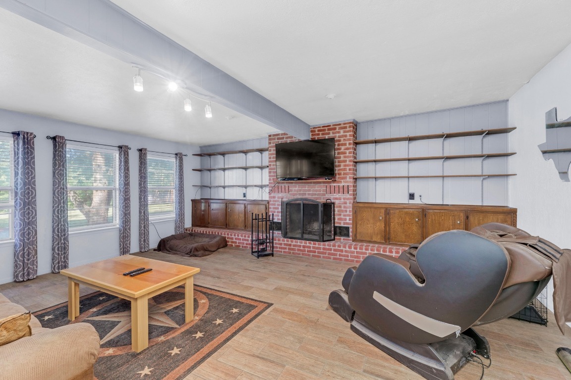148 Meadows Drive Elgin, TX 78621 - Photo 14 of 38 a living room with furniture kitchen view and a fireplace