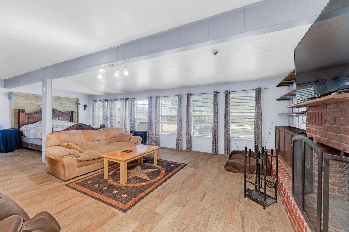 148 Meadows Drive Elgin, TX 78621 - Photo 15 of 38 a living room with furniture a flat screen tv and a large window