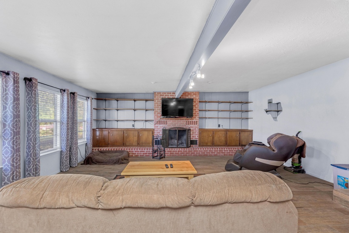 148 Meadows Drive Elgin, TX 78621 - Photo 19 of 38 a living room with furniture a flat screen tv and a fireplace