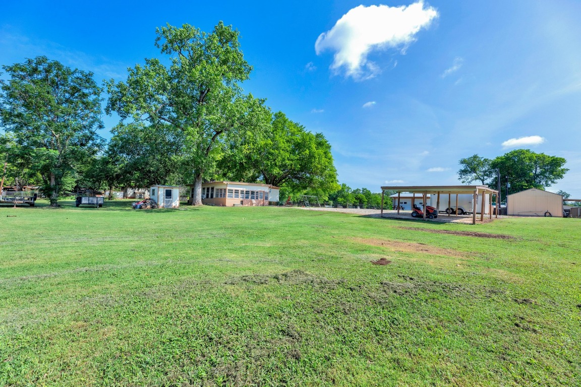 148 Meadows Drive Elgin, TX 78621 - Photo 2 of 38 a front view of a house with garden