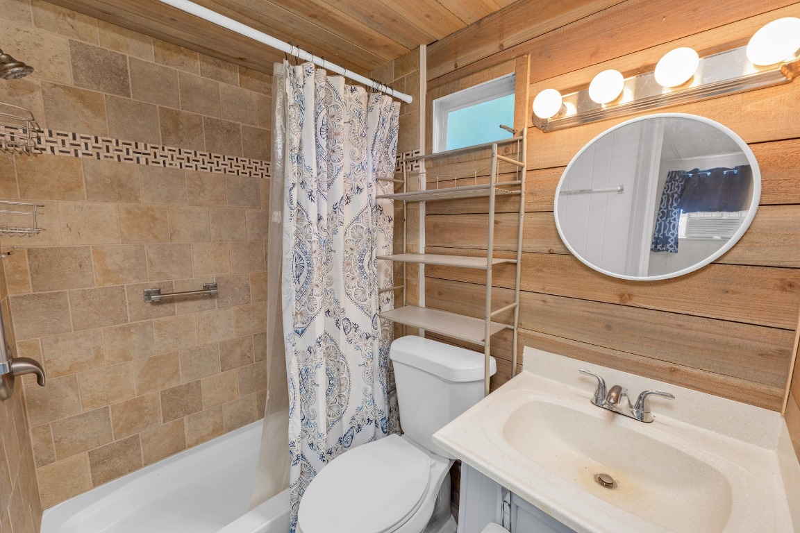 148 Meadows Drive Elgin, TX 78621 - Photo 22 of 38 a bathroom with a sink a toilet and a mirror
