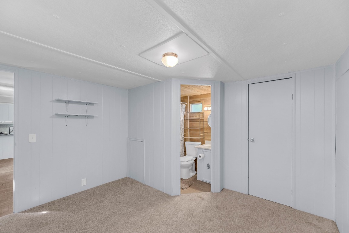 148 Meadows Drive Elgin, TX 78621 - Photo 23 of 38 an empty room with a fireplace and a window