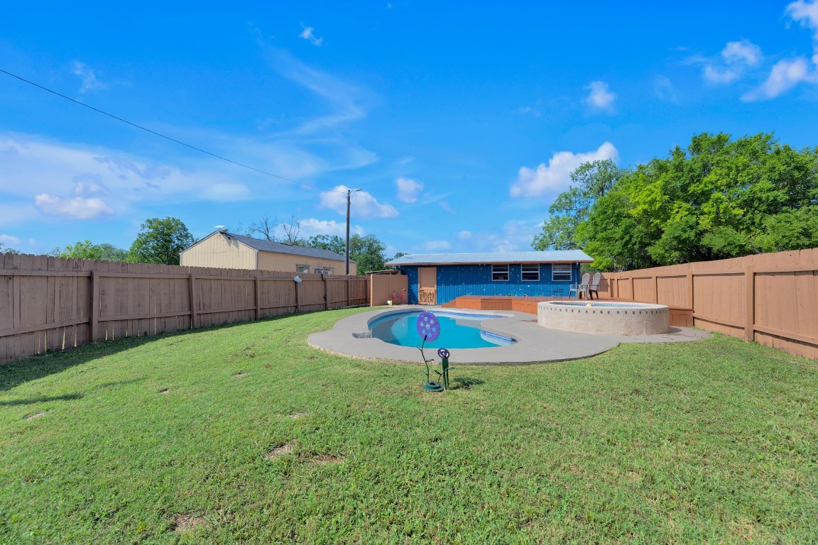 148 Meadows Drive Elgin, TX 78621 - Photo 30 of 38 a view of a backyard with wooden fence