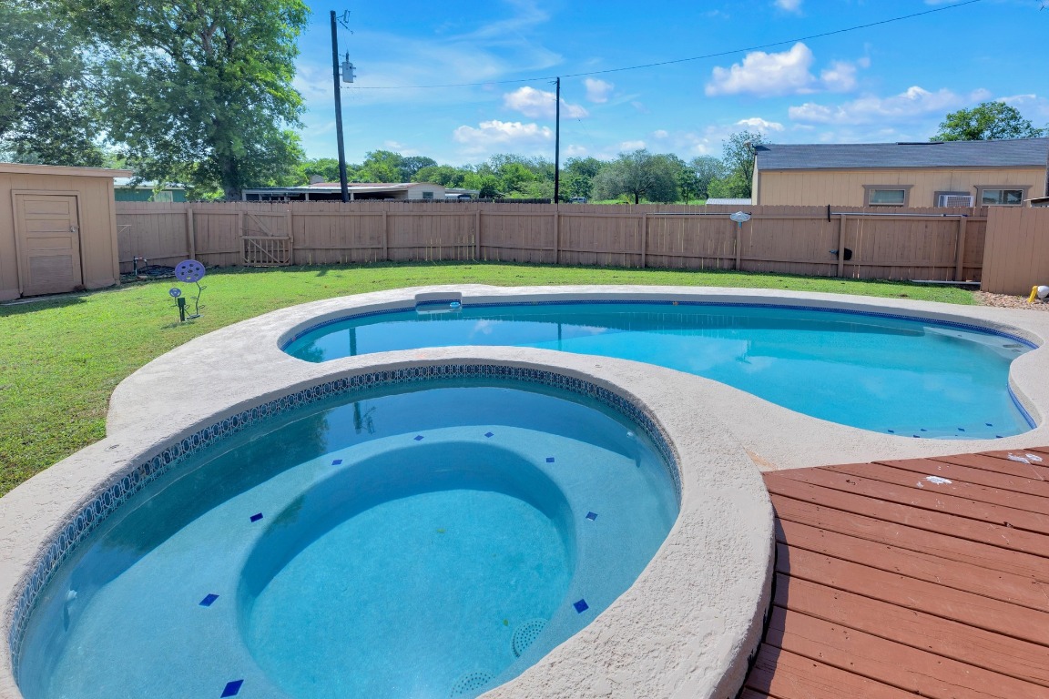 148 Meadows Drive Elgin, TX 78621 - Photo 31 of 38 a view of a swimming pool with a back yard