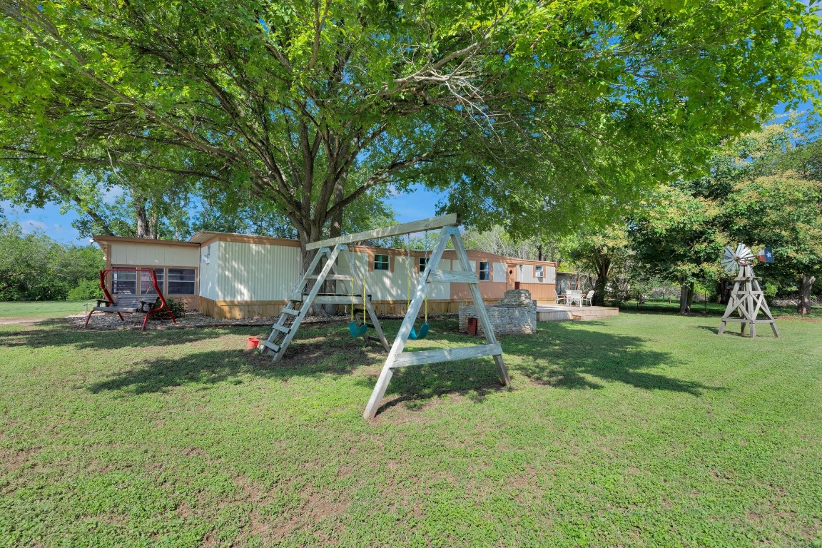 148 Meadows Drive Elgin, TX 78621 - Photo 33 of 38 a view of a house with a yard