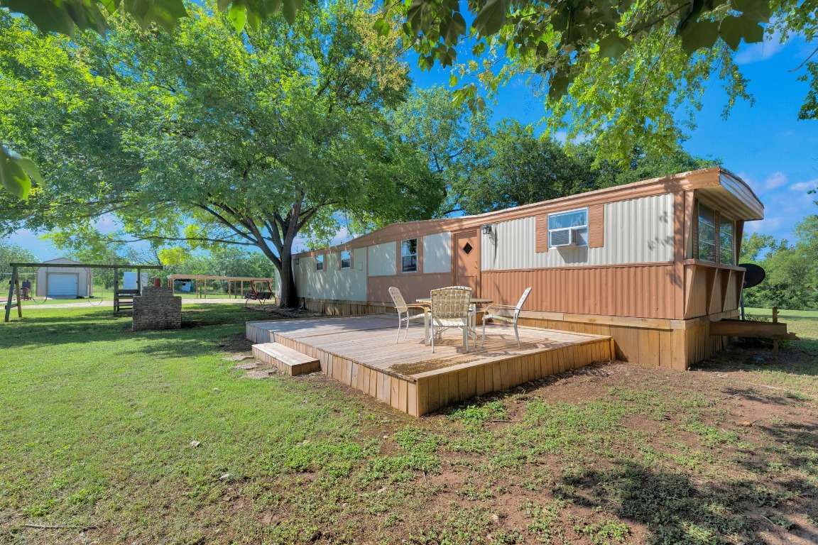 148 Meadows Drive Elgin, TX 78621 - Photo 35 of 38 a view of a house with backyard and a tree