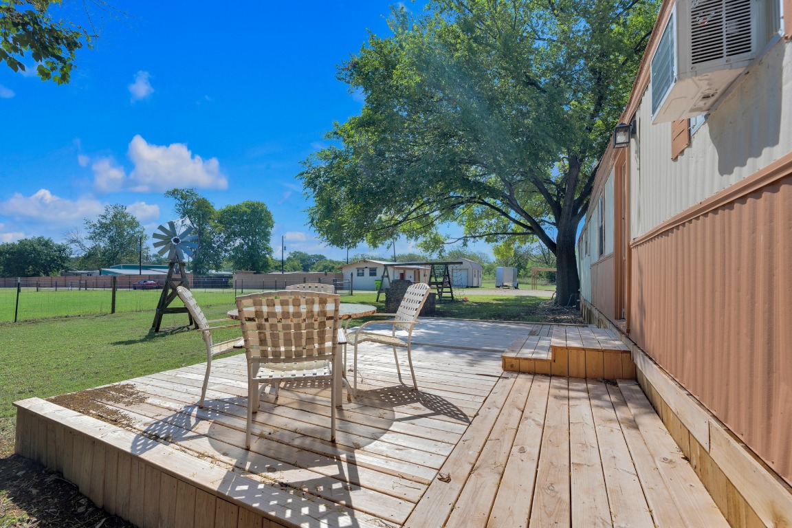 148 Meadows Drive Elgin, TX 78621 - Photo 36 of 38 a view of a patio with a table chairs and a fire pit