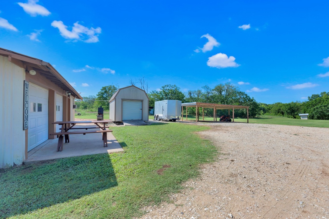 148 Meadows Drive Elgin, TX 78621 - Photo 7 of 38 a view of a house with backyard and a tree