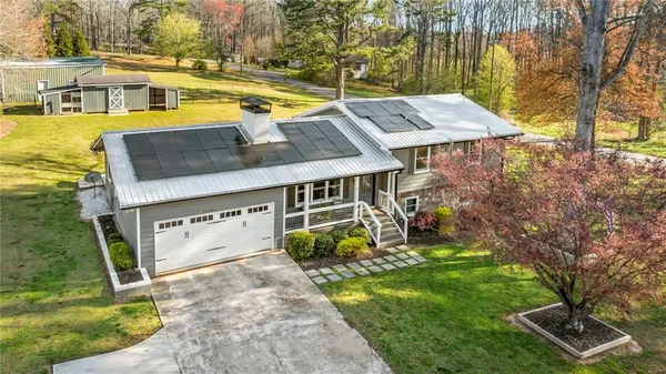 an aerial view of a house with swimming pool and porch