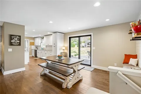 a room with furniture pool table and windows
