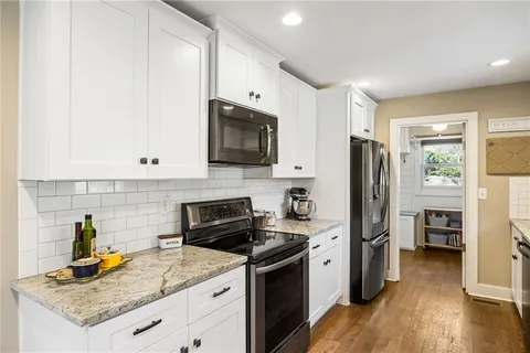 a kitchen with a sink a stove and refrigerator