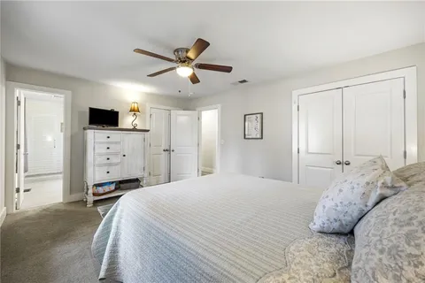 a bedroom with a bed and a tv on the dresser
