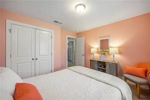 a bedroom with a bed and a lamp