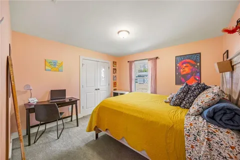 a bedroom with a bed and a desk