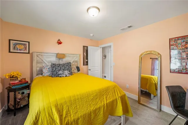 a bed sitting in a bedroom next to a window