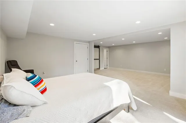 a spacious bedroom with a bed and a couch