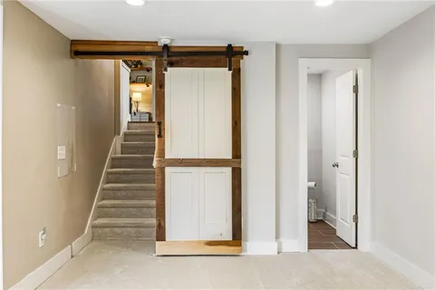 a bathroom with a granite countertop toilet sink and mirror