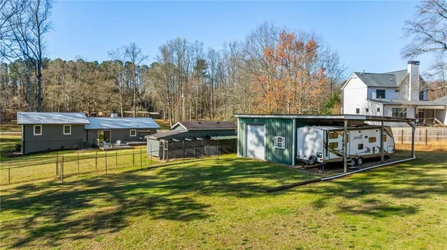 a view of a house with pool and a yard