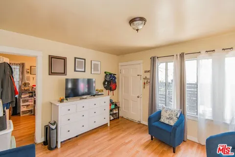 a bedroom with furniture and a flat screen tv