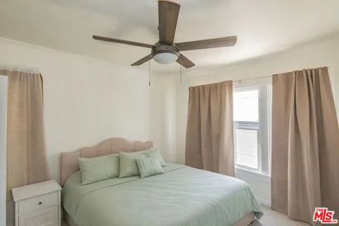 a bed room with a bed and a window