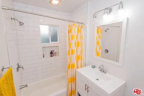 a bathroom with a tub sink and a mirror
