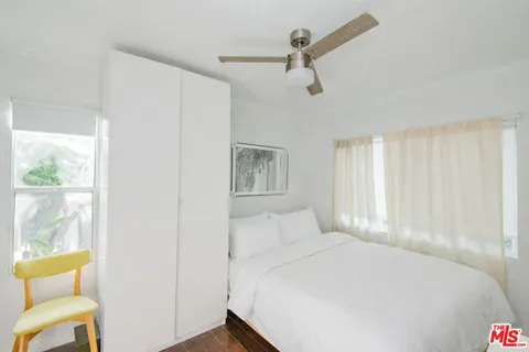 a bedroom with a bed and a chair