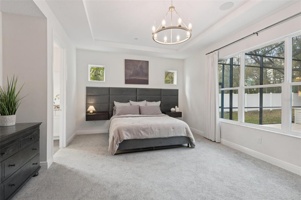 2304 Clement Road Lutz, FL 33549 - Photo 12 of 35 a spacious bedroom with a bed and a window