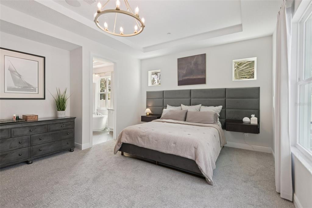 2304 Clement Road Lutz, FL 33549 - Photo 14 of 37 a spacious bedroom with a bed and cabinet