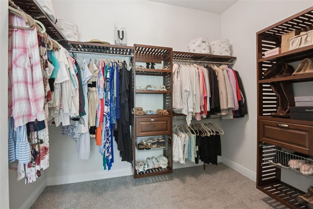 2304 Clement Road Lutz, FL 33549 - Photo 17 of 37 a view of walk in closet with clothes and shoes