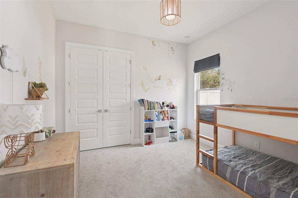 2304 Clement Road Lutz, FL 33549 - Photo 18 of 37 a view of a bedroom with baby crib and furniture