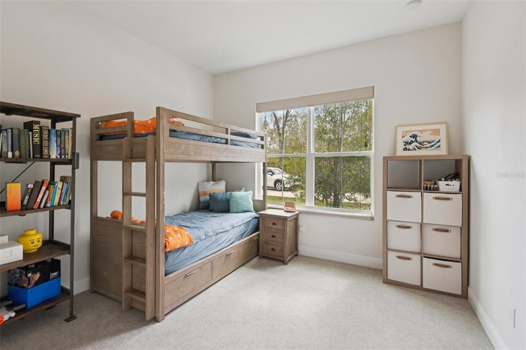 2304 Clement Road Lutz, FL 33549 - Photo 18 of 35 a bedroom with furniture and a window