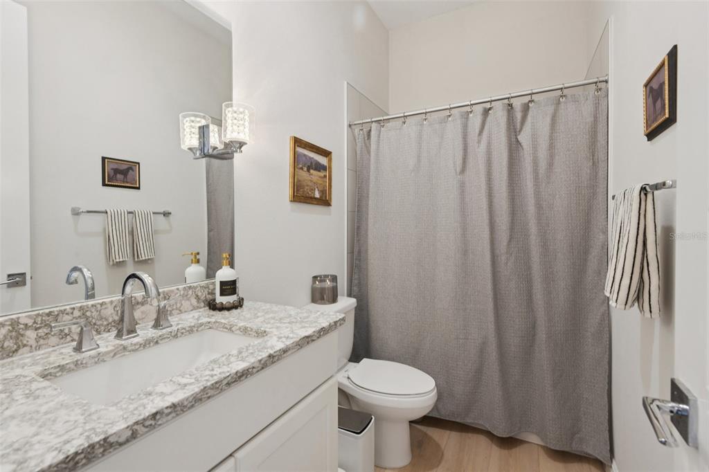 2304 Clement Road Lutz, FL 33549 - Photo 20 of 37 a bathroom with a granite countertop sink and a mirror