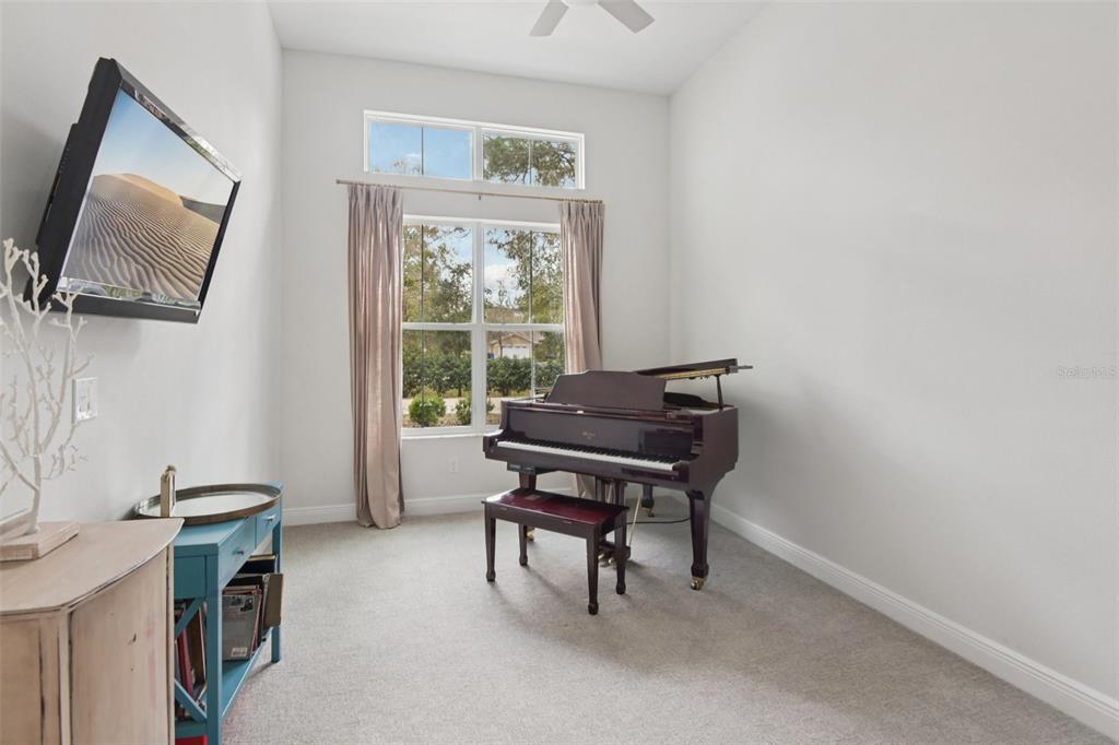 2304 Clement Road Lutz, FL 33549 - Photo 21 of 37 a living room with furniture a flat screen tv and a window