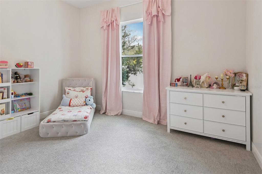 2304 Clement Road Lutz, FL 33549 - Photo 21 of 35 a bedroom with a bed and a window
