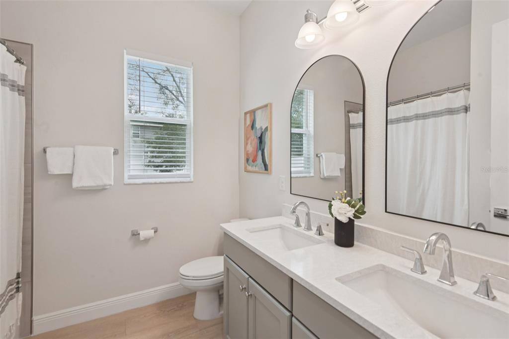 2304 Clement Road Lutz, FL 33549 - Photo 22 of 35 a bathroom with a toilet a sink and mirror